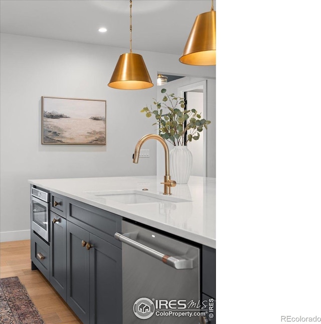 3256 S Corona St, Englewood, CO 80113 - kitchen featuring dishwasher, light wood finished floors, pendant lighting, recessed lighting, and gray cabinets