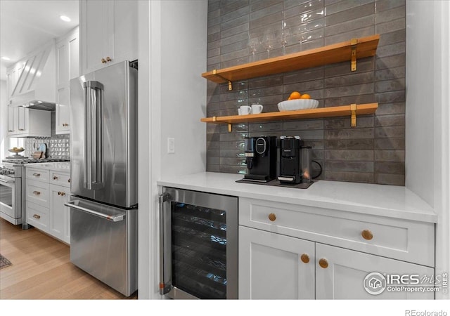 3256 S Corona St, Englewood, CO 80113 - indoor dry bar featuring appliances with stainless steel finishes, wine cooler, tasteful backsplash, custom exhaust hood, and light wood-type flooring