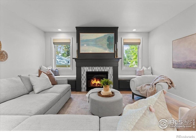 3256 S Corona St, Englewood, CO 80113 - living area featuring wood finished floors, plenty of natural light, a glass covered fireplace, and recessed lighting