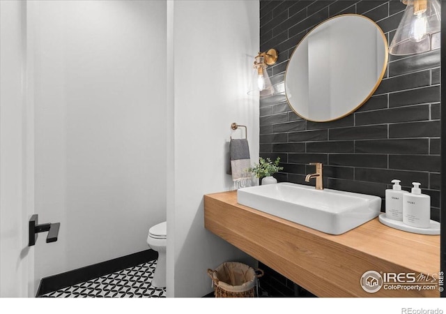 3256 S Corona St, Englewood, CO 80113 - bathroom featuring backsplash, vanity, tile patterned floors, and tile walls
