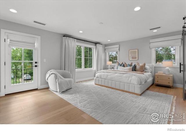 3256 S Corona St, Englewood, CO 80113 - bedroom with multiple windows, access to outside, wood finished floors, and recessed lighting