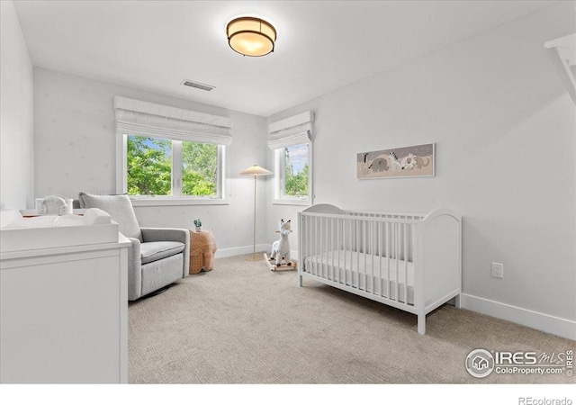 3256 S Corona St, Englewood, CO 80113 - carpeted bedroom featuring a crib and baseboards