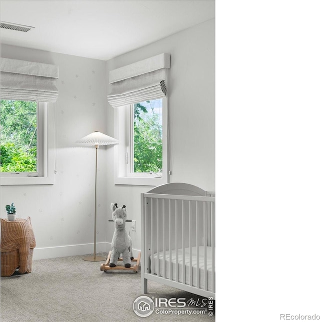 3256 S Corona St, Englewood, CO 80113 - carpeted bedroom featuring multiple windows and a crib