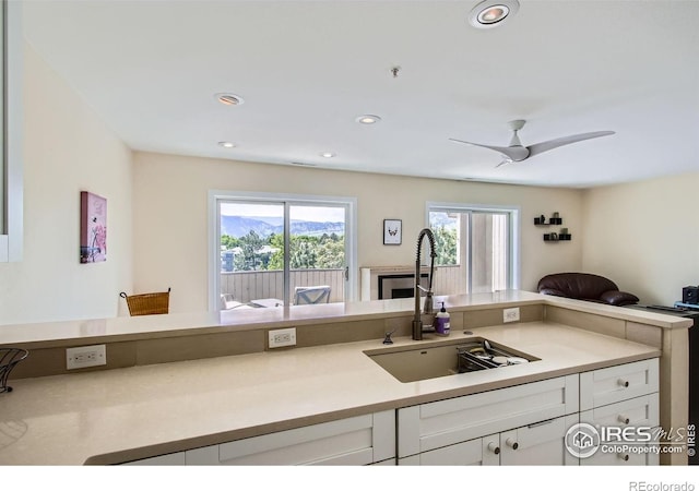 2938 Kalmia Ave Unit 26, Boulder, CO 80301 - kitchen with a sink, white cabinets, light countertops, open floor plan, and recessed lighting