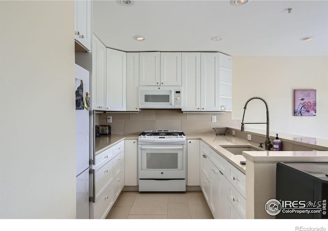 2938 Kalmia Ave Unit 26, Boulder, CO 80301 - kitchen featuring white appliances, a sink, white cabinets, open shelves, and light countertops