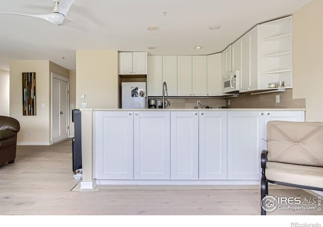 2938 Kalmia Ave Unit 26, Boulder, CO 80301 - kitchen with open shelves, white cabinetry, baseboards, light wood-style flooring, and ceiling fan