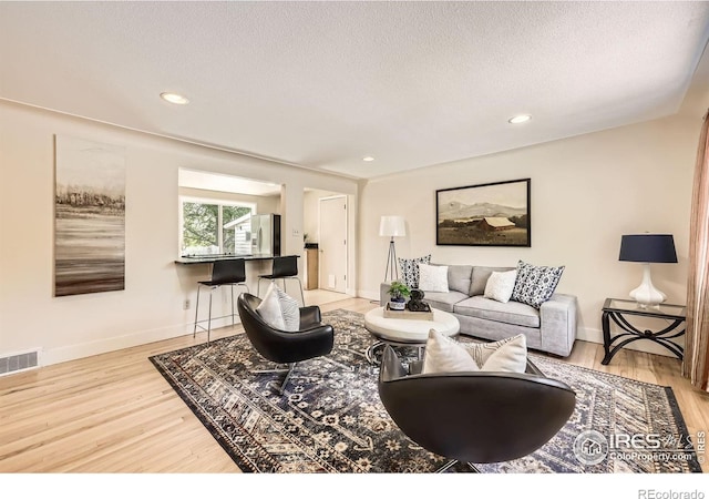 630 S 45th St, Boulder, CO 80305 - living room featuring wood finished floors, baseboards, a textured ceiling, and recessed lighting