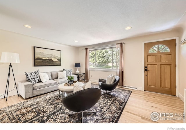 630 S 45th St, Boulder, CO 80305 - living area featuring plenty of natural light, light wood finished floors, a baseboard heating unit, recessed lighting, and baseboards
