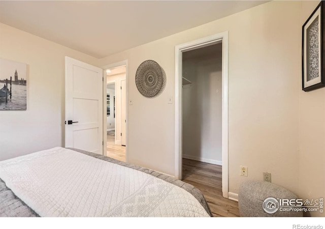 630 S 45th St, Boulder, CO 80305 - bedroom featuring wood finished floors, baseboards, and a spacious closet