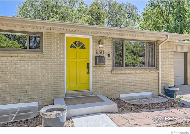 630 S 45th St, Boulder, CO 80305 - doorway to property featuring brick siding and a garage