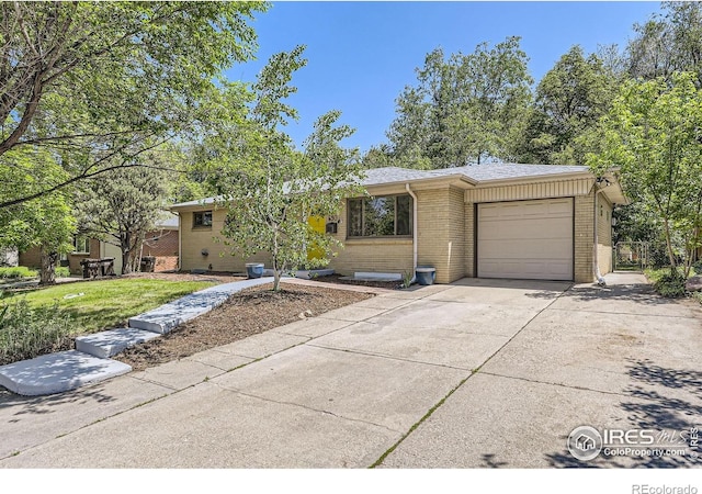 630 S 45th St, Boulder, CO 80305 - view of front of property with brick siding, an attached garage, and concrete driveway