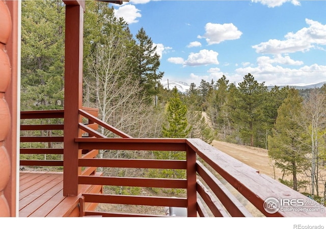 880 Hummer Dr, Nederland, CO 80466 - wooden terrace featuring a view of trees