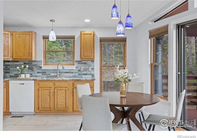880 Hummer Dr, Nederland, CO 80466 - kitchen with white dishwasher, a sink, backsplash, healthy amount of natural light, and recessed lighting