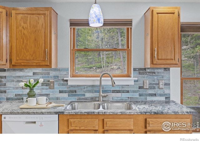 880 Hummer Dr, Nederland, CO 80466 - kitchen featuring dishwasher, a sink, decorative backsplash, and plenty of natural light