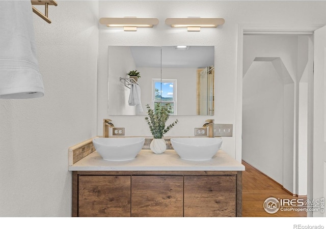 880 Hummer Dr, Nederland, CO 80466 - full bathroom with double vanity and wood finished floors