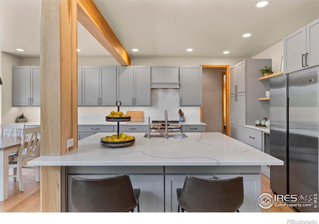 5751 Round Rock Ct, Fort Collins, CO 80528 - kitchen with freestanding refrigerator, gray cabinets, a sink, light stone counters, and recessed lighting