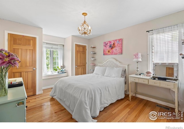 5751 Round Rock Ct, Fort Collins, CO 80528 - bedroom featuring light wood-style floors, a chandelier, and baseboards