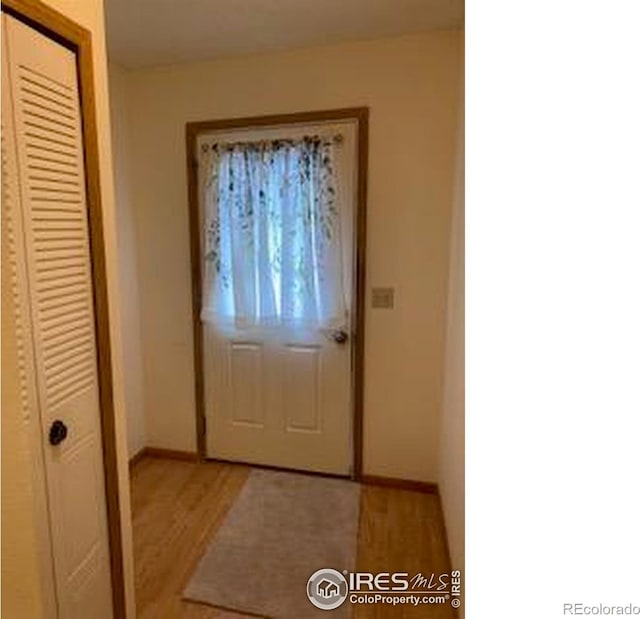 2929 W 81st Ave Unit H, Westminster, CO 80031 - doorway with light wood-type flooring and baseboards
