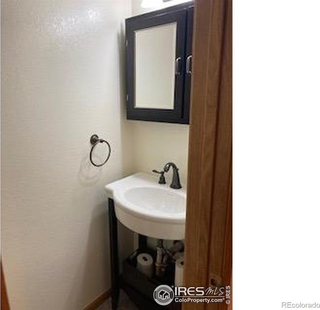 2929 W 81st Ave Unit H, Westminster, CO 80031 - bathroom with baseboards and a sink