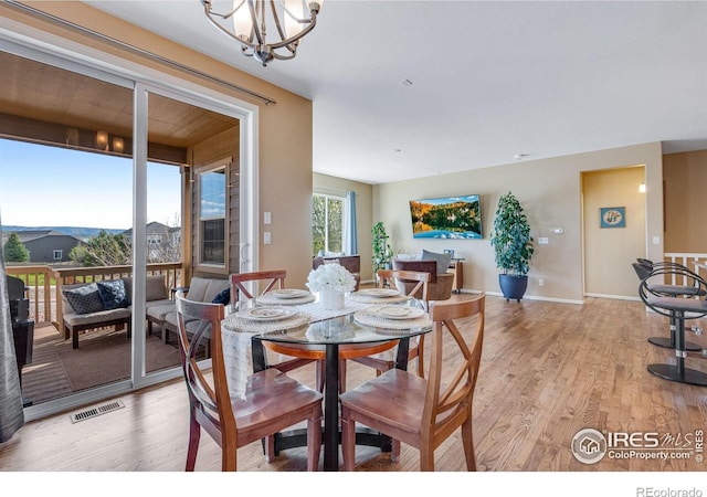 4000 Donnington Cir, Castle Rock, CO 80104 - dining room with light wood finished floors, a chandelier, and baseboards