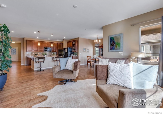 4000 Donnington Cir, Castle Rock, CO 80104 - living area with a chandelier, light wood-style floors, recessed lighting, and baseboards