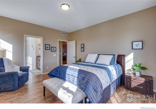 4000 Donnington Cir, Castle Rock, CO 80104 - bedroom featuring light wood finished floors, baseboards, and ensuite bathroom