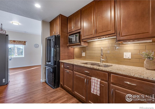 4000 Donnington Cir, Castle Rock, CO 80104 - kitchen with appliances with stainless steel finishes, a sink, baseboards, and backsplash