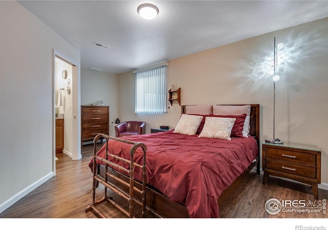 4000 Donnington Cir, Castle Rock, CO 80104 - bedroom featuring wood finished floors, baseboards, a textured ceiling, and a textured wall