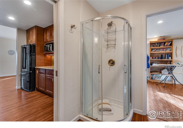 4000 Donnington Cir, Castle Rock, CO 80104 - full bathroom featuring wood finished floors, a shower stall, vanity, recessed lighting, and baseboards