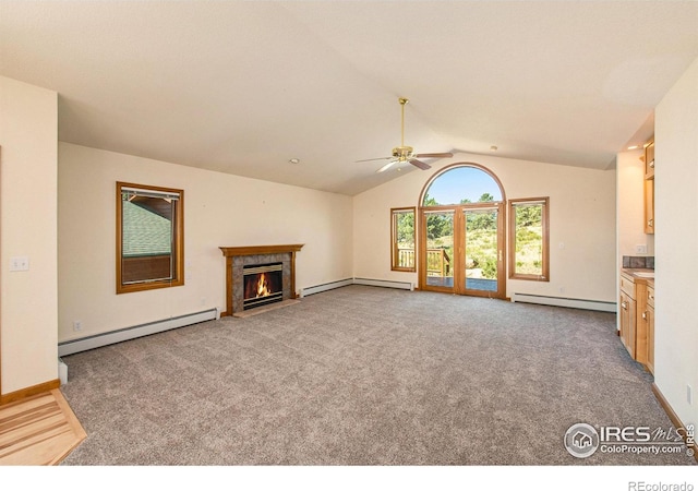 683 Cedar Ridge Cir, Estes Park, CO 80517 - unfurnished living room featuring a baseboard radiator, ceiling fan, a fireplace with flush hearth, vaulted ceiling, and carpet floors