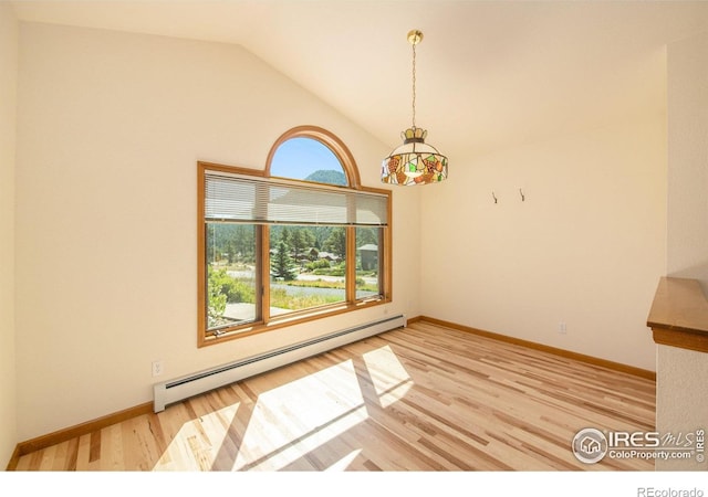 683 Cedar Ridge Cir, Estes Park, CO 80517 - unfurnished dining area with a baseboard heating unit, light wood-style floors, vaulted ceiling, and baseboards