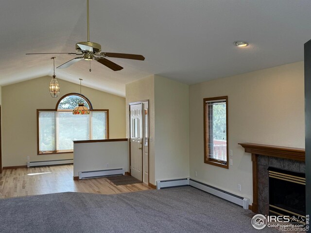 683 Cedar Ridge Cir, Estes Park, CO 80517 - unfurnished living room with a baseboard radiator, lofted ceiling, ceiling fan, and a tiled fireplace