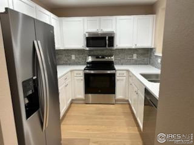 2218 Stetson Creek Dr Unit C, Fort Collins, CO 80528 - kitchen featuring stainless steel appliances, white cabinets, and backsplash