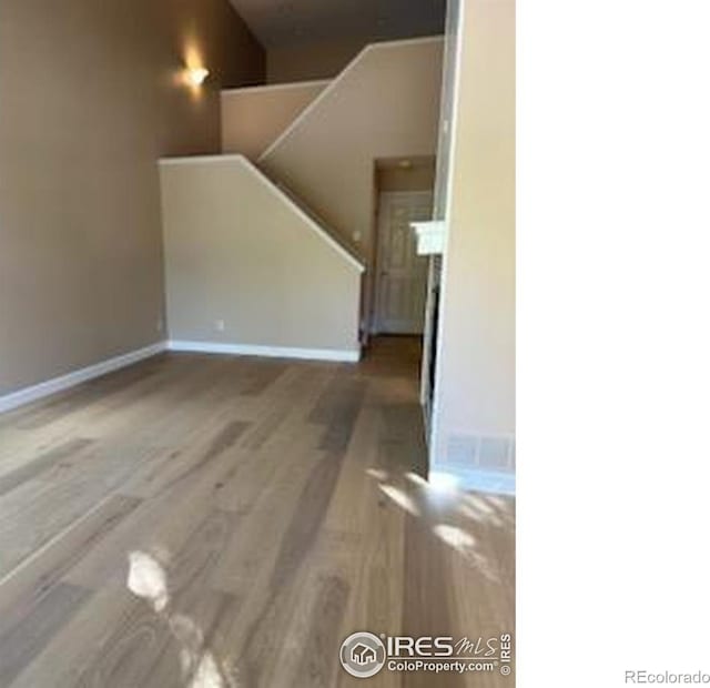 2218 Stetson Creek Dr Unit C, Fort Collins, CO 80528 - unfurnished living room with wood finished floors and baseboards