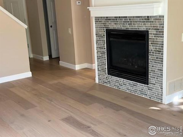 2218 Stetson Creek Dr Unit C, Fort Collins, CO 80528 - detailed view of a tile fireplace, wood finished floors, and baseboards