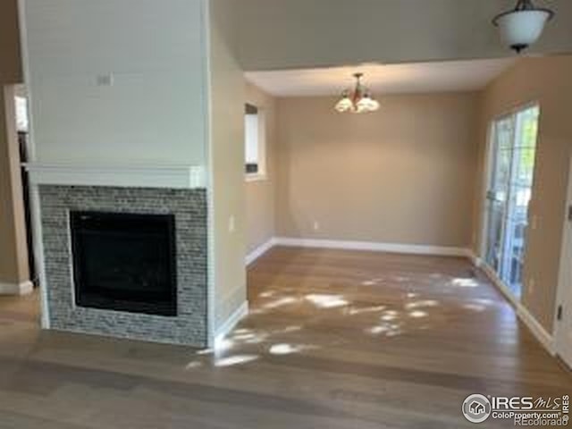 2218 Stetson Creek Dr Unit C, Fort Collins, CO 80528 - unfurnished living room with baseboards, a chandelier, and wood finished floors