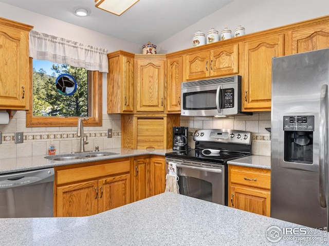 3807 Dollar Lake Dr, Estes Park, CO 80517 - kitchen featuring appliances with stainless steel finishes, a sink, tasteful backsplash, light countertops, and vaulted ceiling