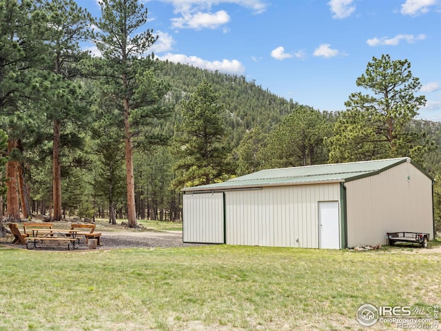 3807 Dollar Lake Dr, Estes Park, CO 80517 - view of pole building featuring a wooded view and a yard