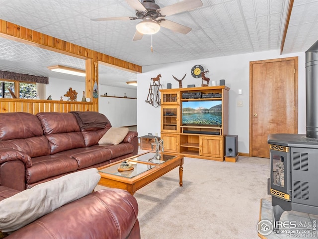 3807 Dollar Lake Dr, Estes Park, CO 80517 - carpeted living area with a ceiling fan, a wood stove, and baseboards