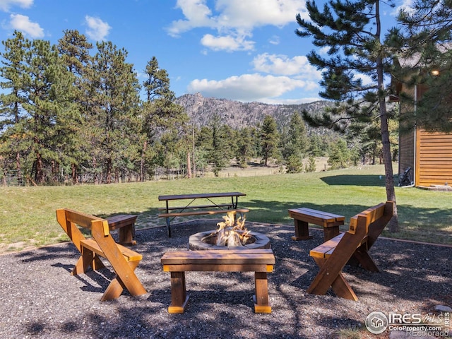 3807 Dollar Lake Dr, Estes Park, CO 80517 - view of grassy yard with an outdoor fire pit, a mountain view, and a wooded view