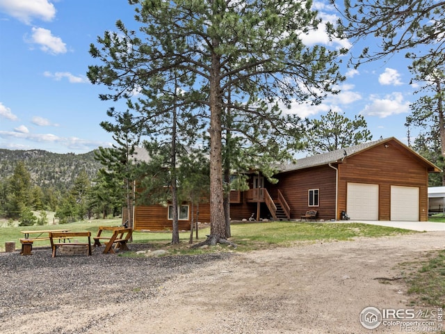 3807 Dollar Lake Dr, Estes Park, CO 80517 - view of property exterior featuring stairs, dirt driveway, and a yard