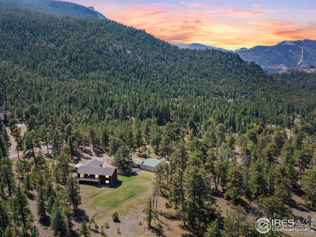 3807 Dollar Lake Dr, Estes Park, CO 80517 - aerial view of property and surrounding area featuring a forest and a mountainous background