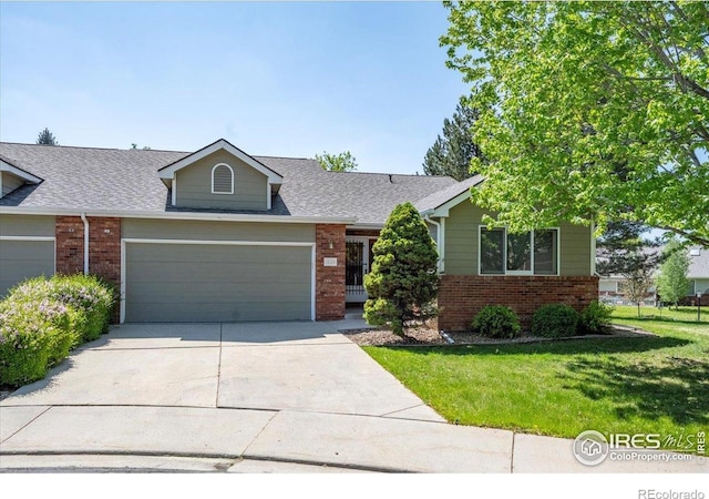 1528 16th Pl, Longmont, CO 80501 - view of front of property featuring brick siding, a garage, concrete driveway, and a front yard