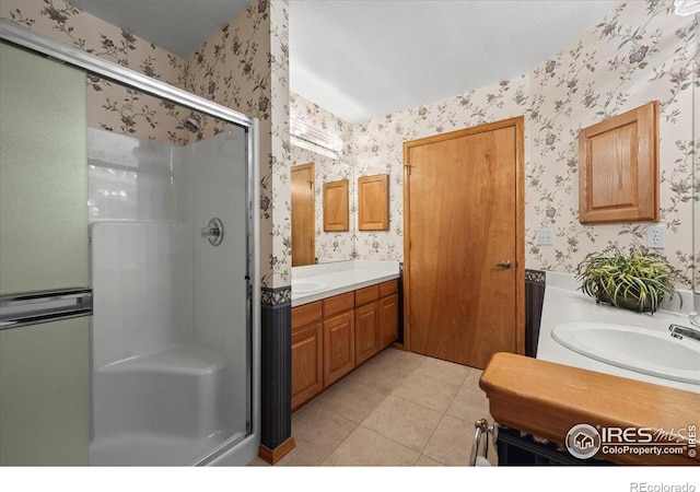 1528 16th Pl, Longmont, CO 80501 - full bath featuring wallpapered walls, a stall shower, vanity, and tile patterned flooring