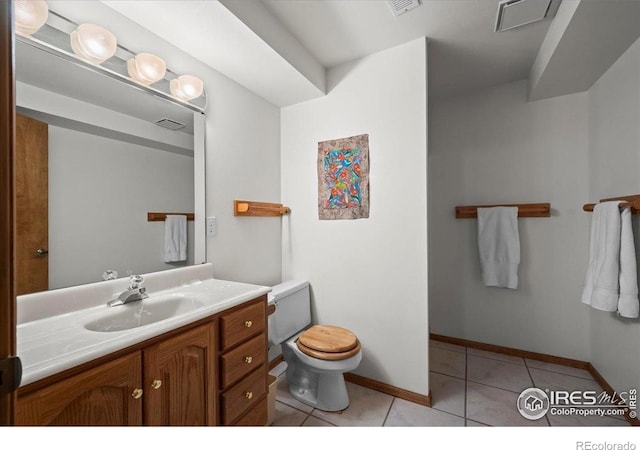 1528 16th Pl, Longmont, CO 80501 - bathroom featuring toilet, vanity, tile patterned floors, and baseboards