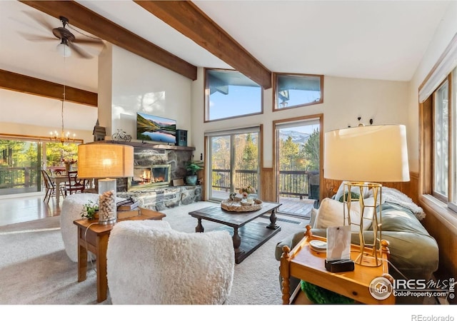 216 N Gold Flake, Breckenridge, CO 80424 - living area featuring a stone fireplace, a chandelier, carpet, ceiling fan, and a wainscoted wall