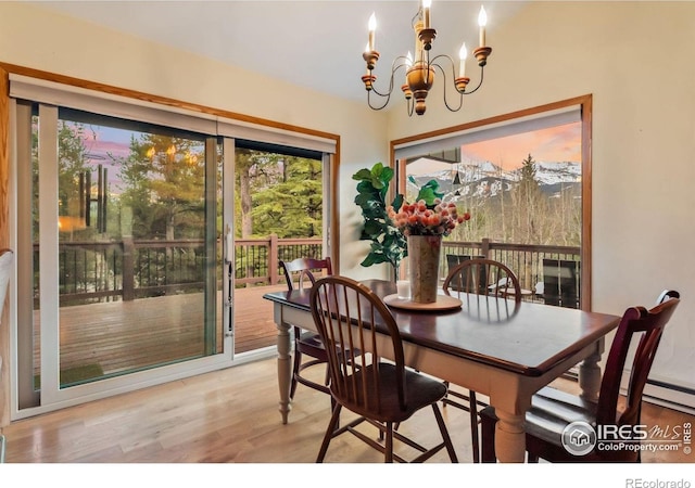 216 N Gold Flake, Breckenridge, CO 80424 - dining room with a chandelier, healthy amount of natural light, and light wood-style floors