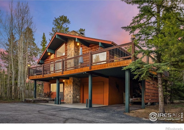 216 N Gold Flake, Breckenridge, CO 80424 - rear view of property featuring stone siding, a deck, and a garage