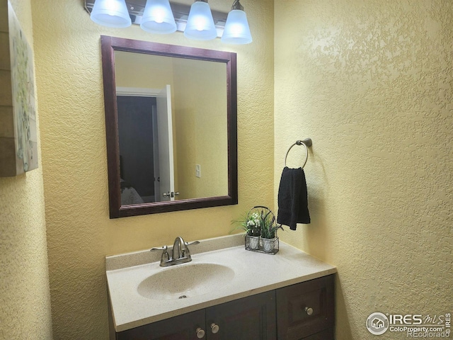 936 E 4th St, Loveland, CO 80537 - bathroom featuring a textured wall and vanity