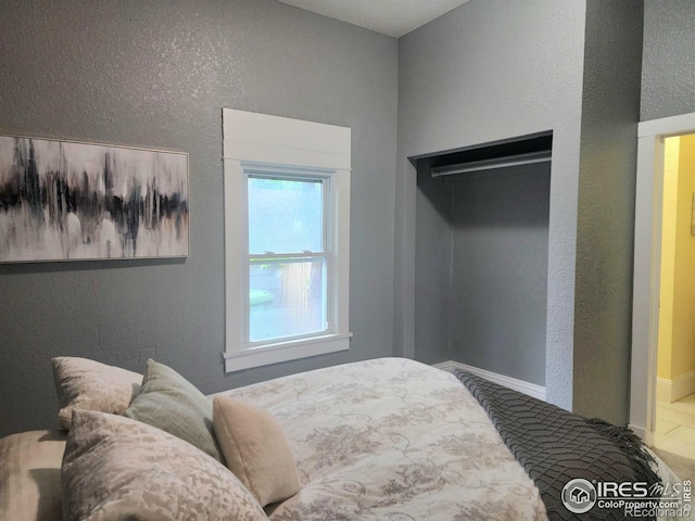 936 E 4th St, Loveland, CO 80537 - bedroom with a textured wall and baseboards